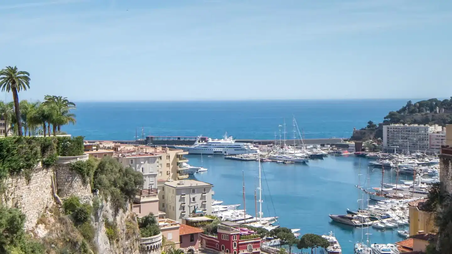Yachts moored in Port Hercule, Monaco, at sunset